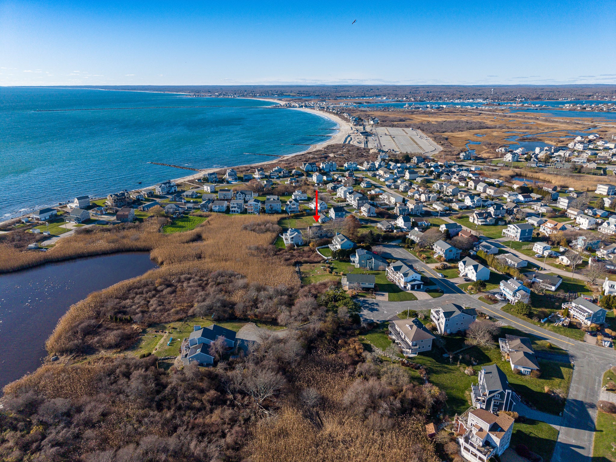 Aerial view of a coastal town with houses and a body of water.