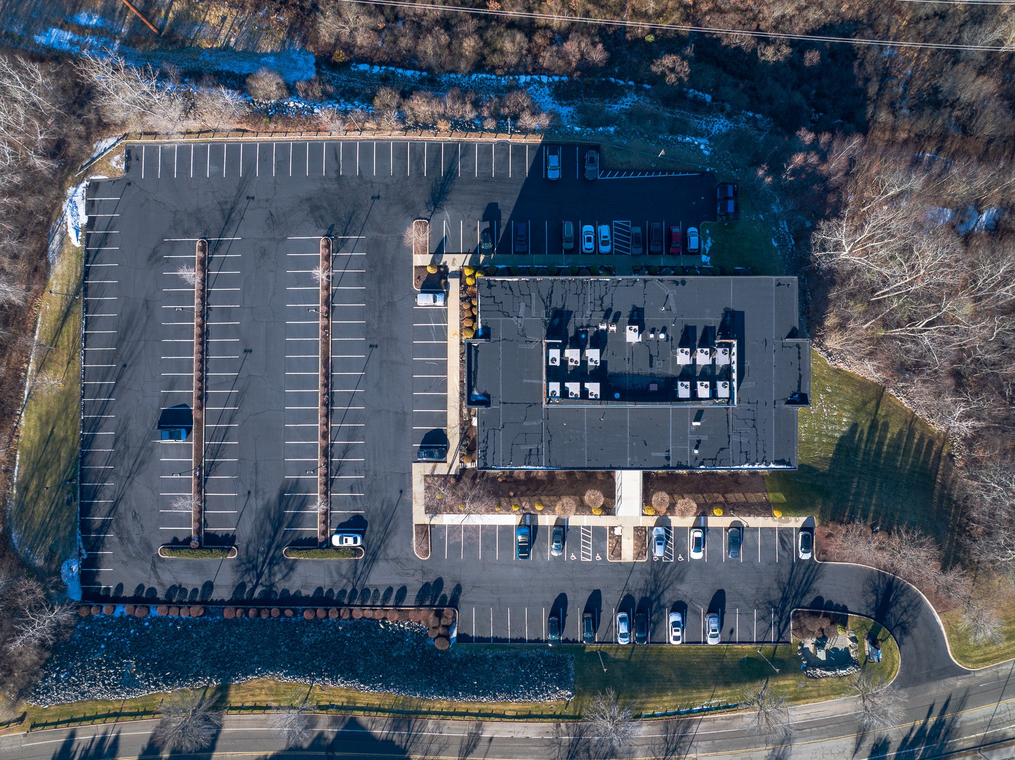overhead vide of a commercial building and parking lot