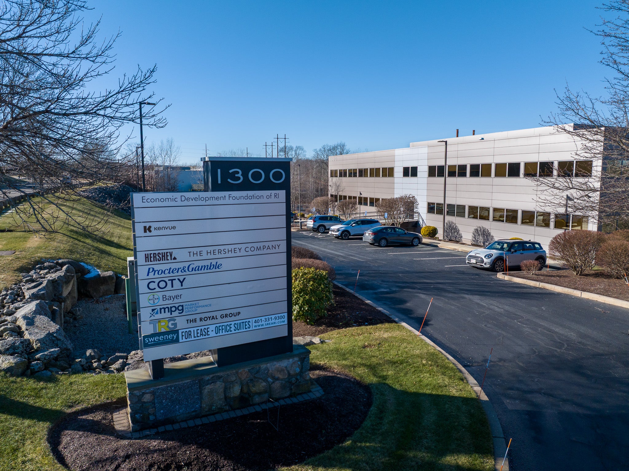 Commercial building with a large sign in front on a clear day
