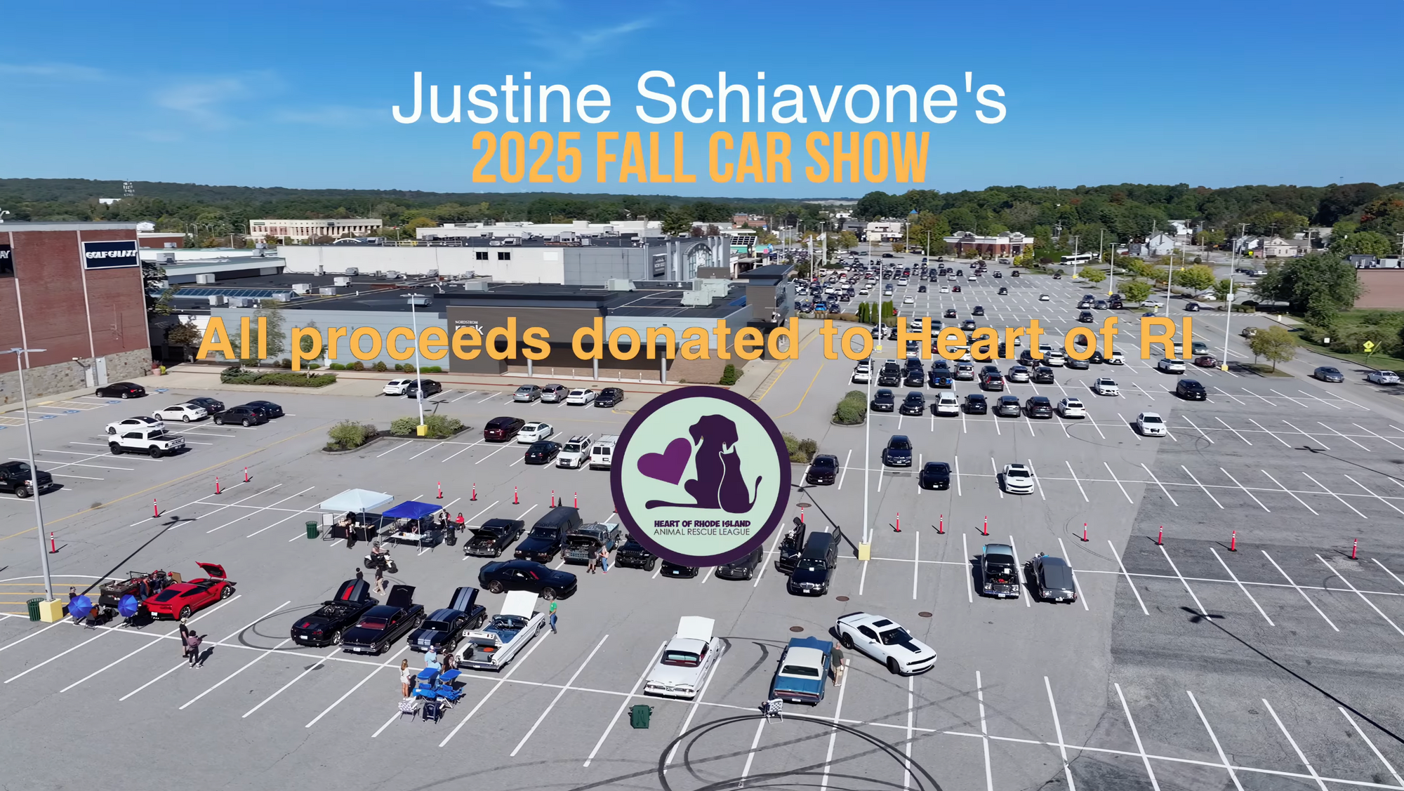 Car show event with attendees and vehicles in a parking lot, featuring Justine Schiavone's 2025 Fall Car Show branding.