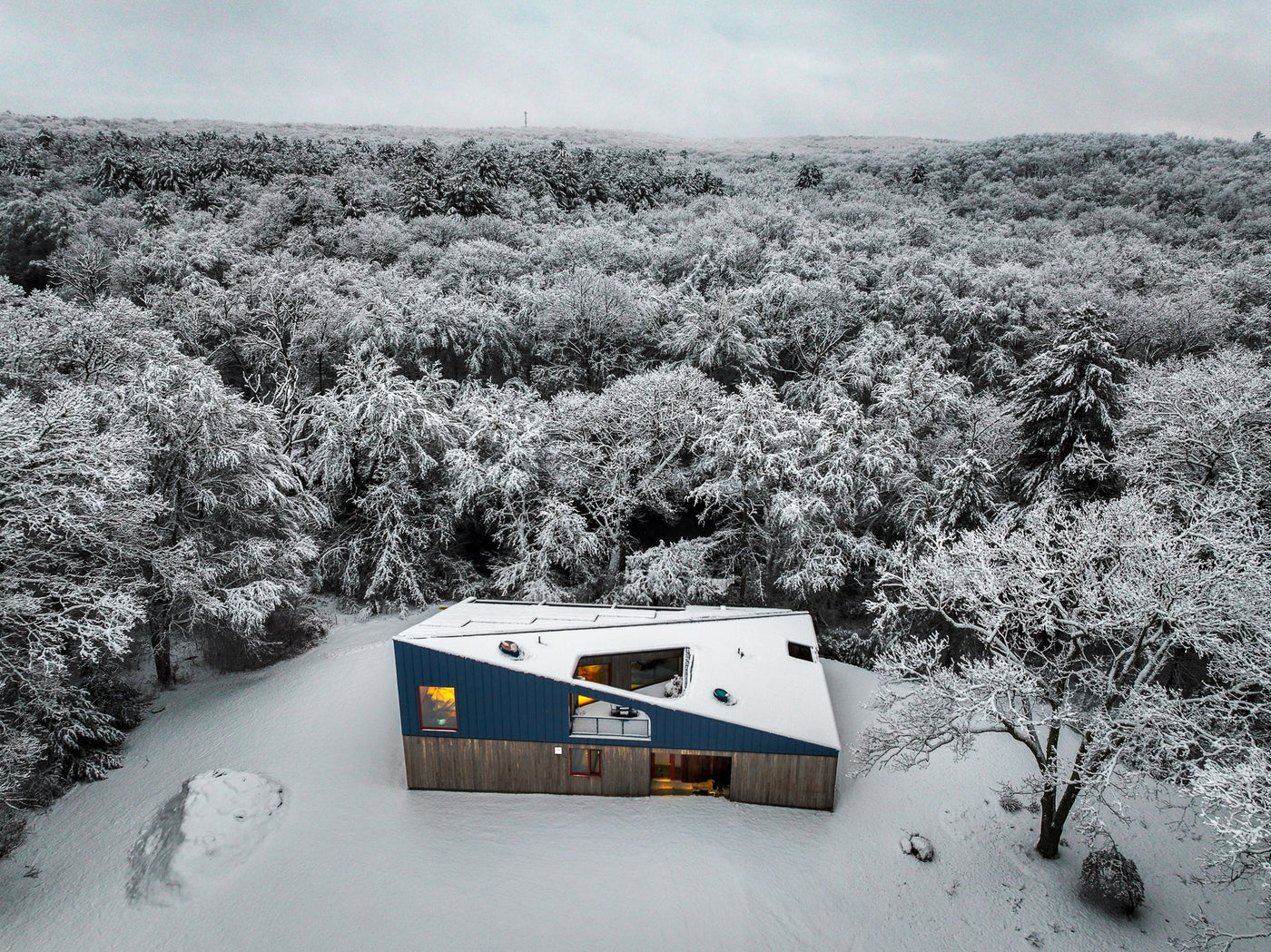 Drone photo of unique home in the snow