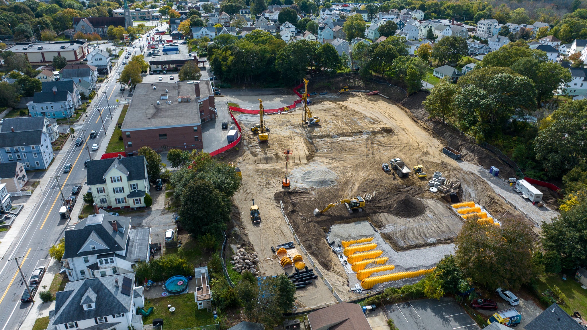 Aerial view of a construction site with surrounding residential area