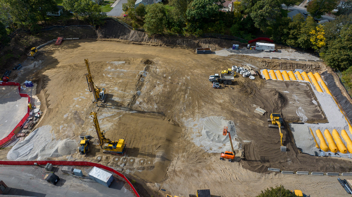Aerial view of a construction site with various pieces of equipment and materials.