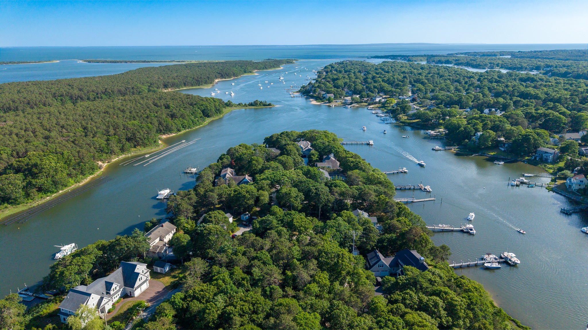 Coastal aerial shot of a peninsula and multiple inlets with boats